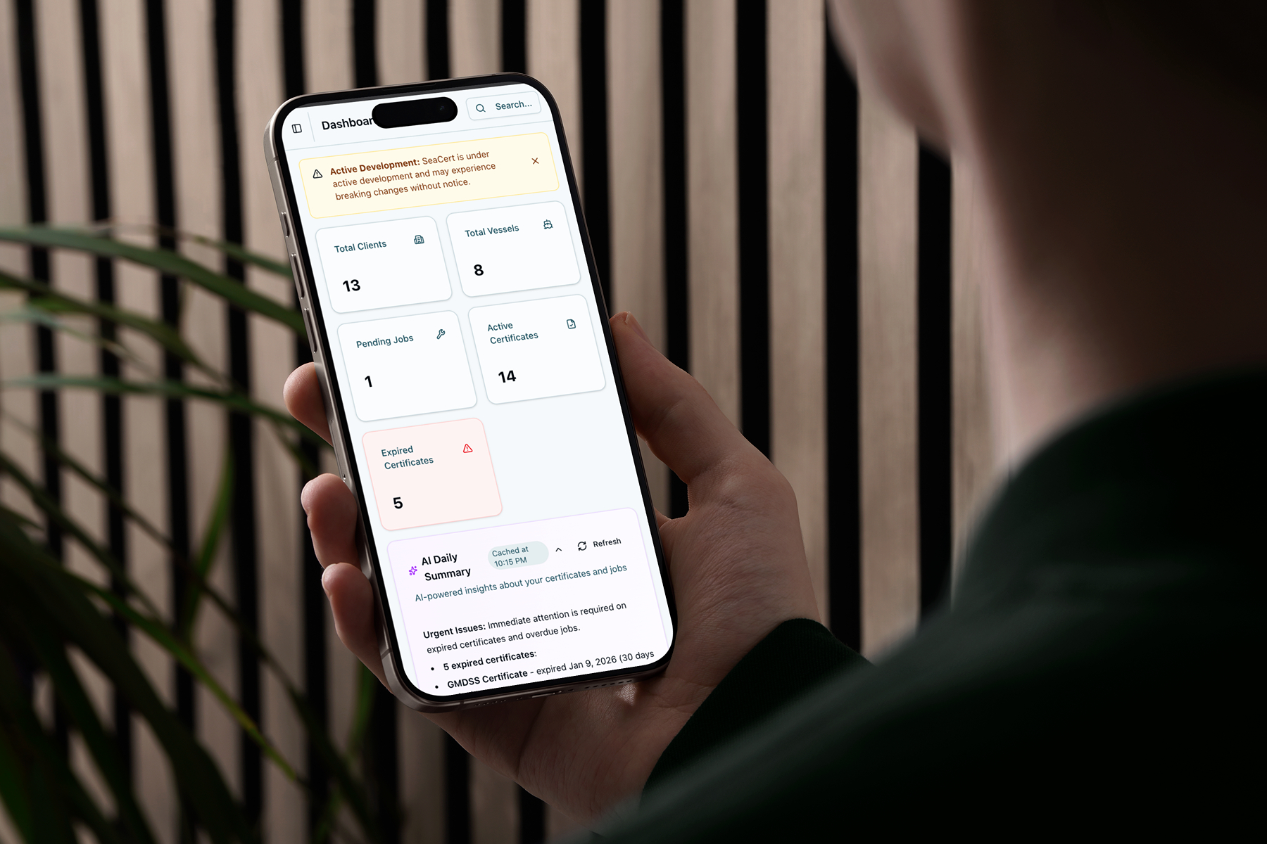 SeaCert mobile dashboard on iPhone showing clients, vessels, and AI summary